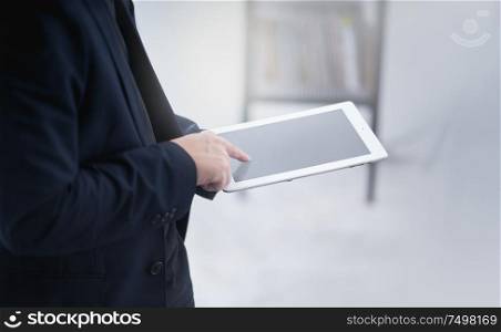Businessman working on a digital tablet .