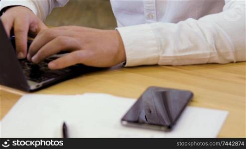 Businessman working on a laptop in small business office for startup team.. Small business owner working on laptop
