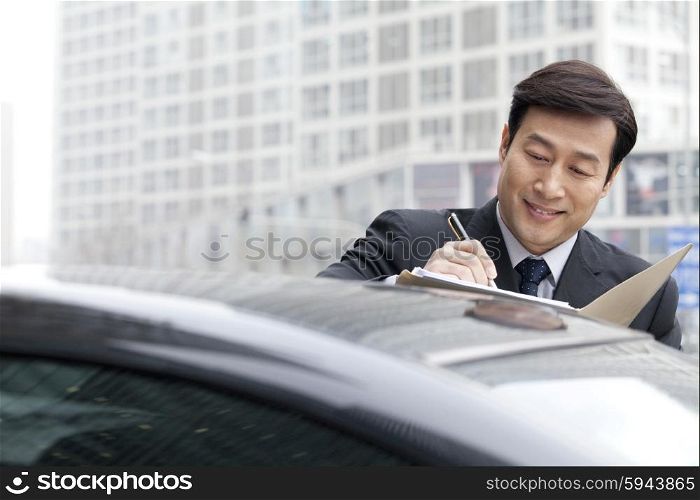 Businessman working on car