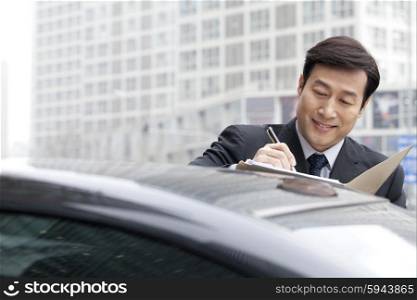 Businessman working on car