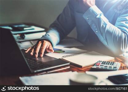 businessman working on desk office with using computer laptop, finance accounting concept