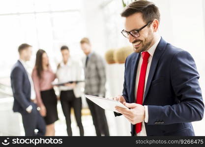 Businessman working on digital tablet in modern office