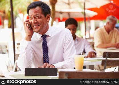Businessman Working On Digital Tablet In Outdoor Caf?