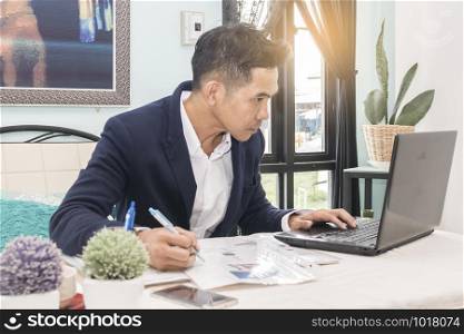 Businessman working on his finances at his desk in his office