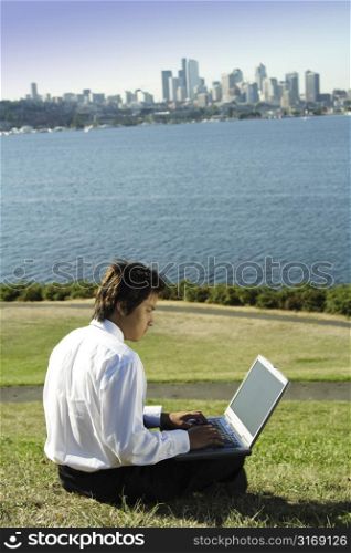 Businessman working on his laptop in a park