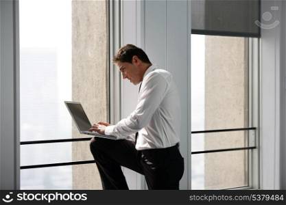businessman working on his laptop in the hall