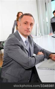 Businessman working on laptop computer in office