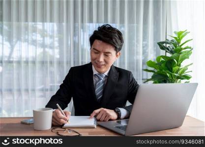 Businessman working on laptop for on office desk workspace. Smart executive researching financial business data or planning strategic business marketing with computer on table. Jubilant. Businessman working on laptop for on office desk workspace. Jubilant