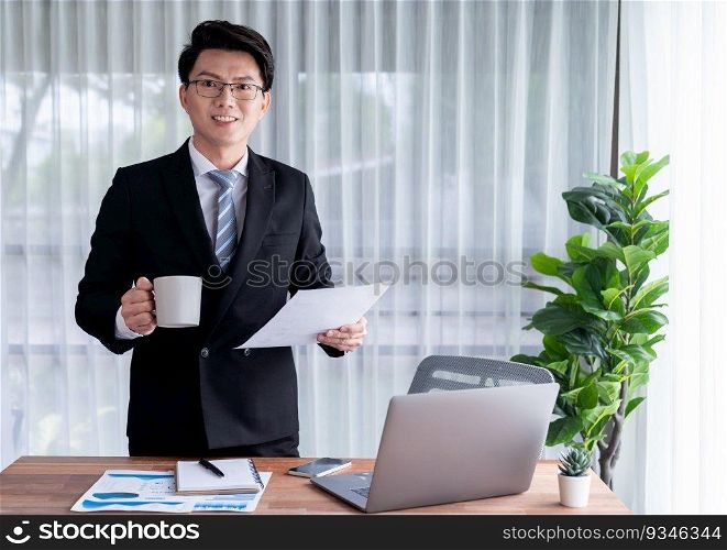 Businessman working on laptop for on office desk workspace portrait. Smart executive researching financial business data or planning strategic business marketing with computer on table. Jubilant. Businessman working on laptop for on office desk portrait. Jubilant