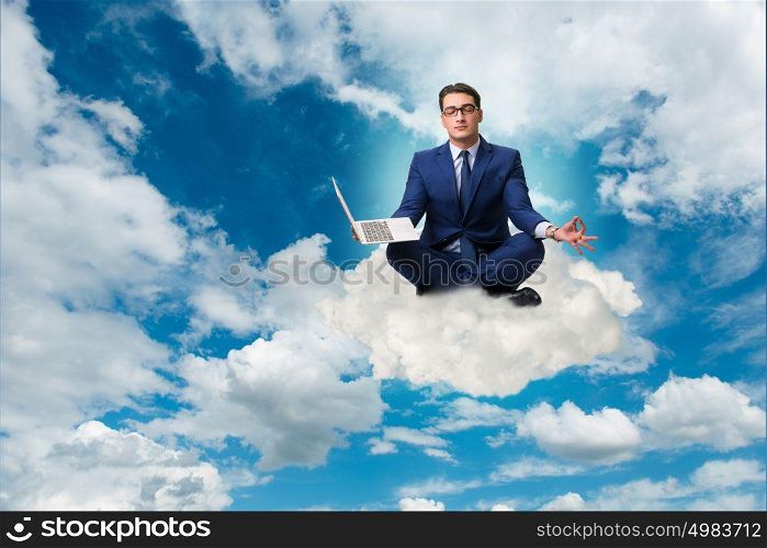 Businessman working on laptop in the sky