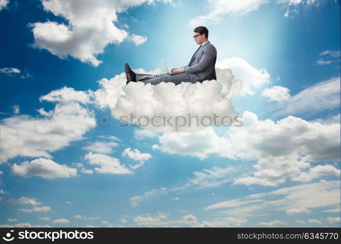 Businessman working on laptop in the sky