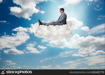 Businessman working on laptop in the sky