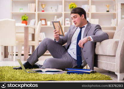 Businessman working on the floor at home