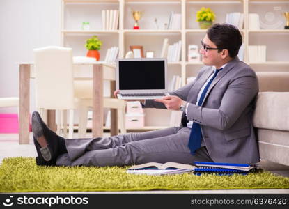 Businessman working on the floor at home