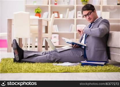 Businessman working on the floor at home