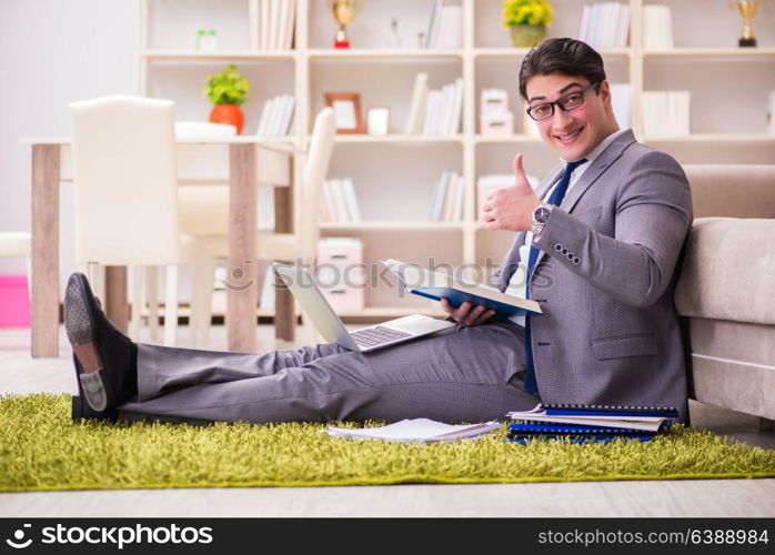 Businessman working on the floor at home