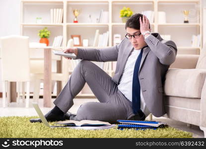 Businessman working on the floor at home