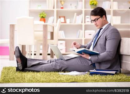 Businessman working on the floor at home