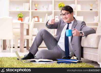 Businessman working on the floor at home