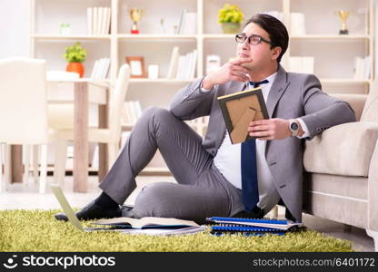 Businessman working on the floor at home