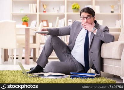 Businessman working on the floor at home