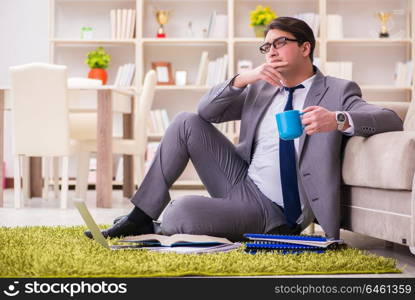 Businessman working on the floor at home