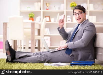 Businessman working on the floor at home