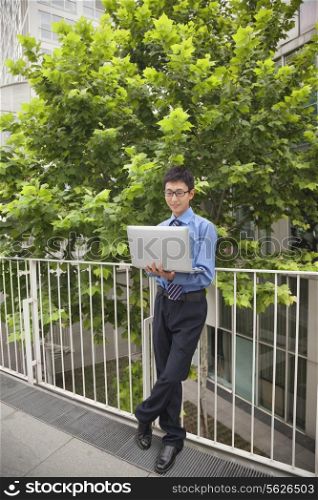 Businessman working outdoors with his laptop