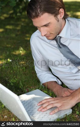 Businessman working outside on laptop