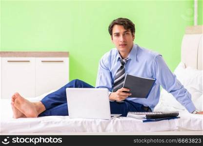 Businessman working overtime in hotel room