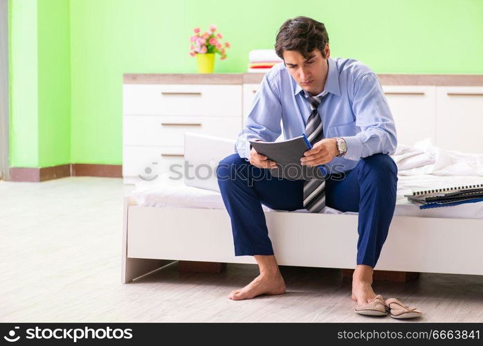 Businessman working overtime in hotel room