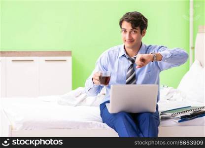 Businessman working overtime in hotel room. The businessman working overtime in hotel room