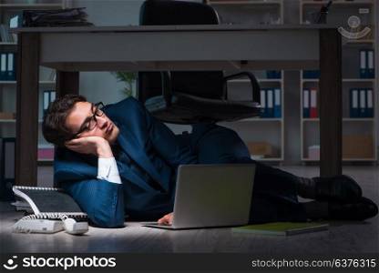 Businessman working overtime long hours late in office