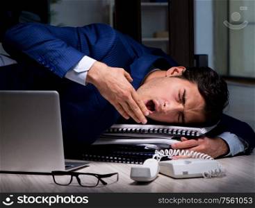 Businessman working overtime long hours late in office. The businessman working overtime long hours late in office