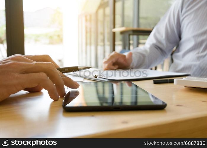 Businessman working together and using tablet at a modern office