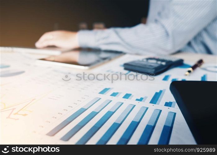 Businessman working with calculator at the office and Financial data analyzing counting