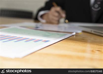 businessman working with chart diagram analysis paperwork document, laptop computer on office desk