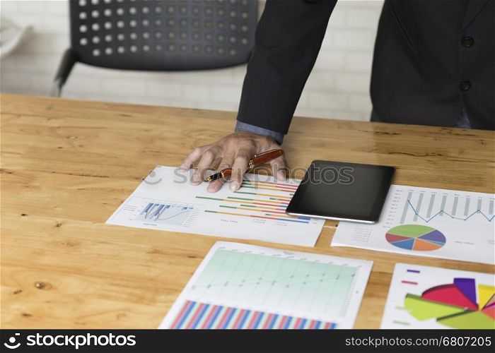 businessman working with chart diagram analysis paperwork document, tablet on office desk