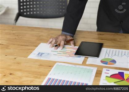 businessman working with chart diagram analysis paperwork document, tablet on office desk