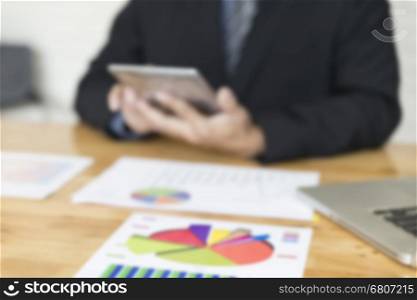 businessman working with chart diagram analysis paperwork document, tablet on office desk - blur for use as background