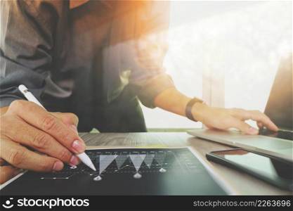 businessman working with digital laptop computer and smart phone with digital business strategy layer effect on wooden desk as concept