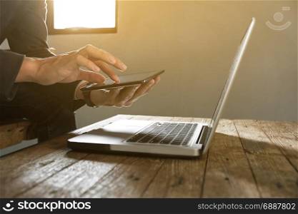 businessman working with digital tablet and laptop with financial business strategy at a workplace