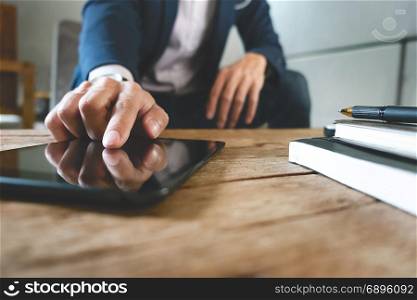 businessman working with digital tablet and laptop with financial business strategy at a workplace