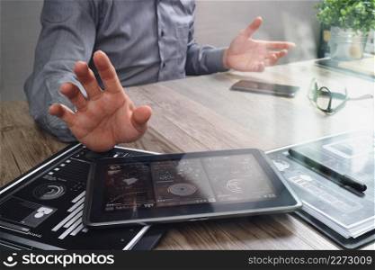 businessman working with digital tablet computer and smart phone and laptop computer with financial business strategy layer effect on wooden desk,filter effect
