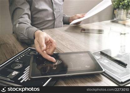 businessman working with digital tablet computer and smart phone and laptop computer with financial business strategy layer effect on wooden desk,filter effect