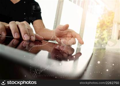 businessman working with digital tablet computer with digital business strategy layer effect on wooden desk as concept