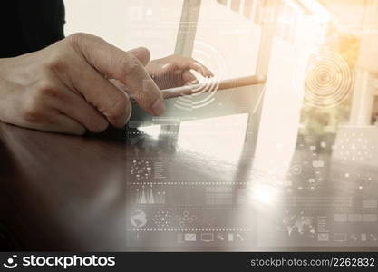 businessman working with digital tablet computer with digital business strategy layer effect on wooden desk as concept