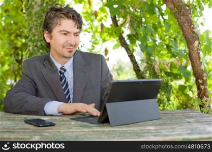businessman working with digital tablet, outdoors