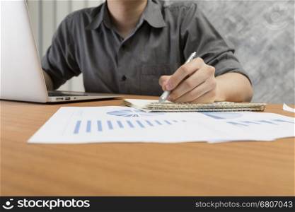 businessman working with document and computer notebook laptop on office desk