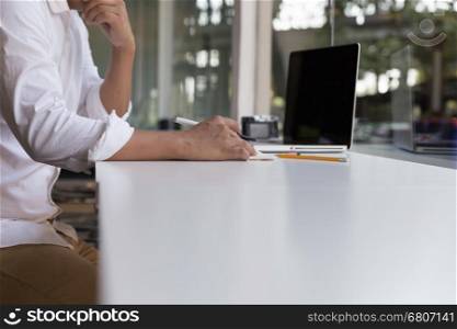 businessman working with document and laptop computer for use as office workplace concept